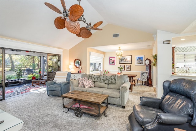 living room with high vaulted ceiling, light colored carpet, and ceiling fan with notable chandelier