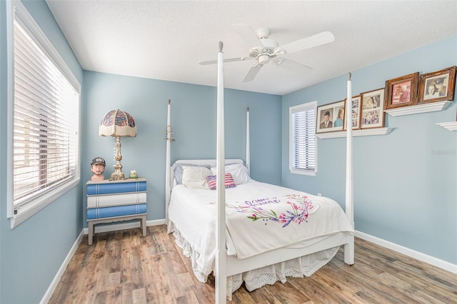 bedroom featuring ceiling fan, a textured ceiling, and hardwood / wood-style flooring