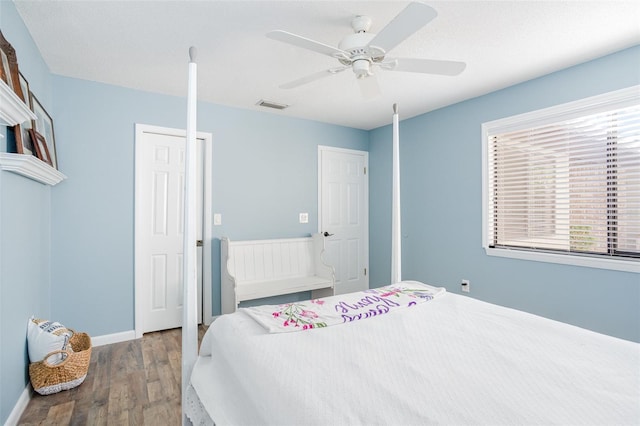 bedroom featuring hardwood / wood-style flooring, ceiling fan, and a textured ceiling