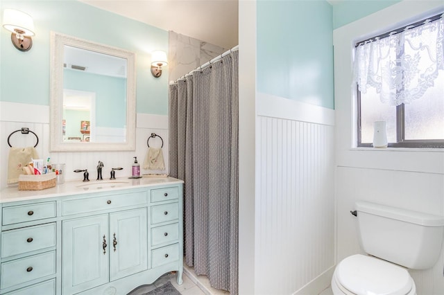 bathroom with walk in shower, vanity, and toilet