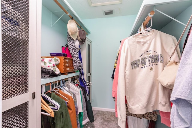 walk in closet with carpet flooring