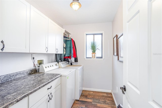 laundry area featuring washer and dryer, dark hardwood / wood-style floors, and cabinets