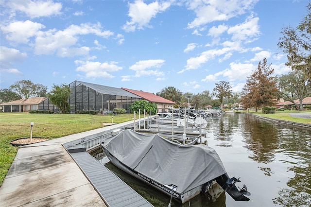 dock area with a yard and a water view