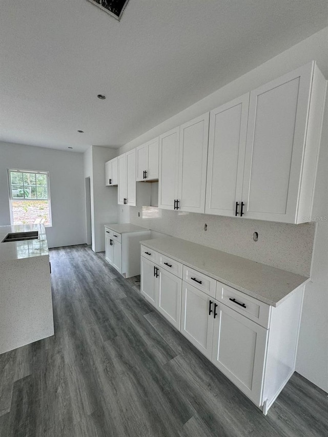 kitchen with white cabinets and dark wood-type flooring