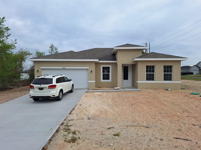 view of front of house with a shingled roof, concrete driveway, a garage, and stucco siding