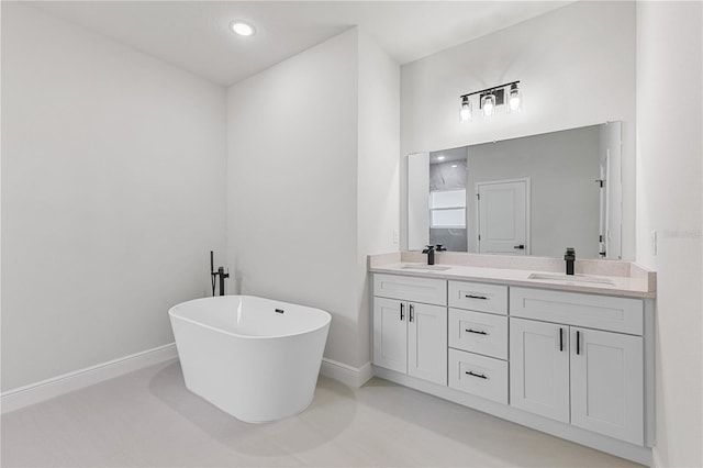 bathroom with a tub to relax in and vanity