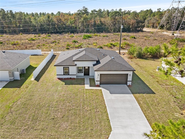 view of front of house with a garage, a shingled roof, driveway, stucco siding, and a front yard