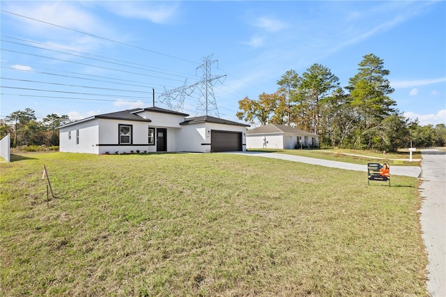 view of front facade featuring a front yard and a garage