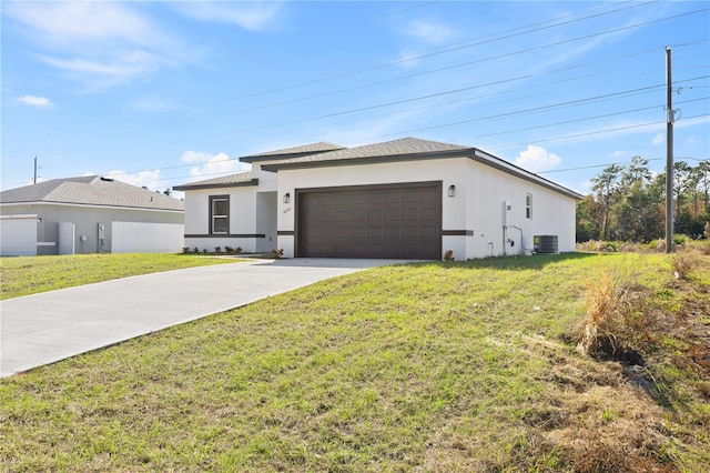 view of front of property with cooling unit, a front yard, and a garage