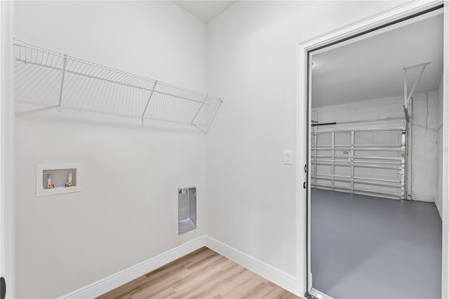 clothes washing area featuring hookup for a washing machine, electric dryer hookup, and wood-type flooring