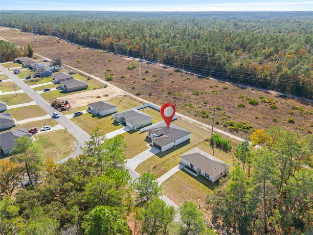 drone / aerial view with a wooded view