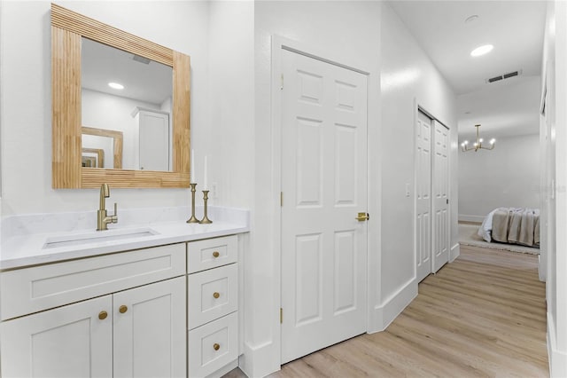 bathroom with vanity and hardwood / wood-style floors