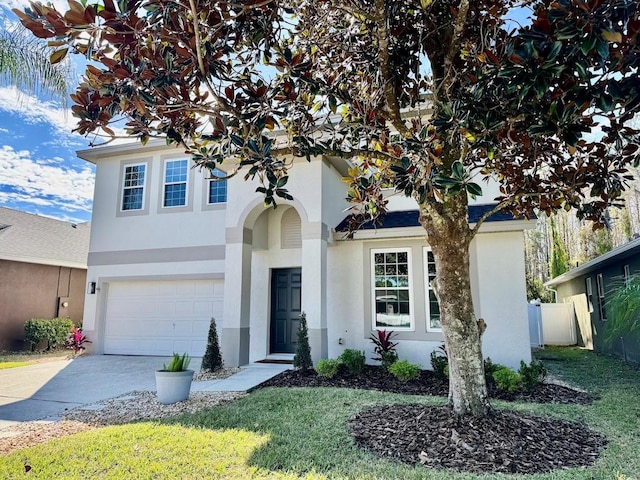 view of front of property featuring a garage and a front lawn