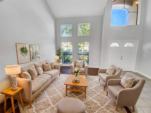 living room featuring tile patterned flooring and high vaulted ceiling