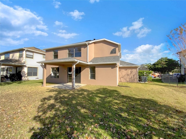 rear view of property featuring central AC unit, a patio area, and a lawn