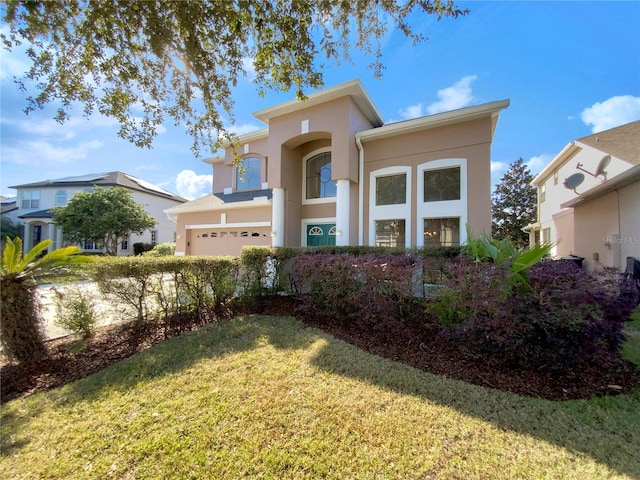 view of front of home with a front yard and a garage