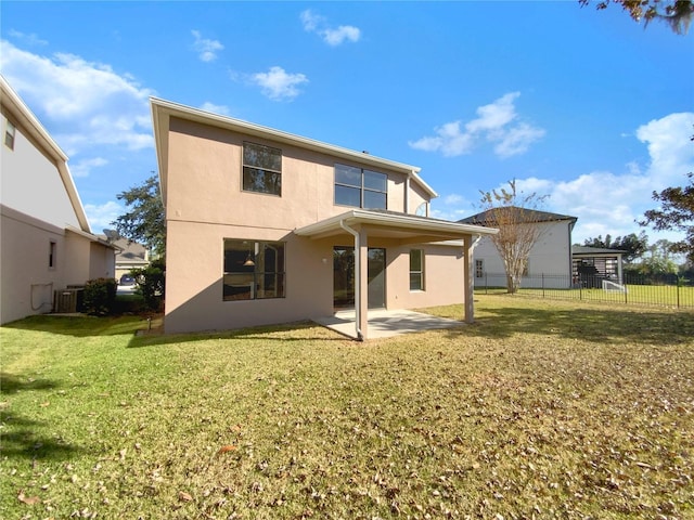 back of house with a patio area, a yard, and central AC