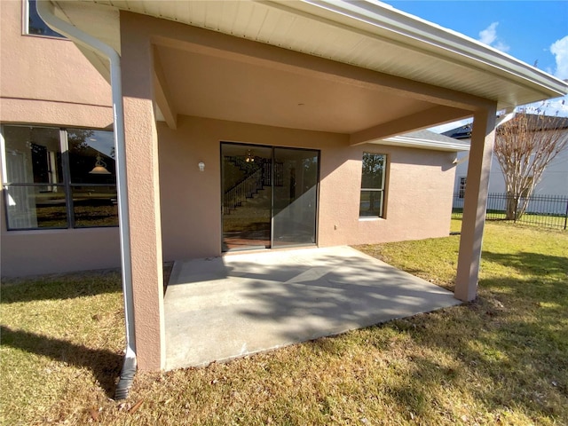 rear view of property featuring a yard and a patio