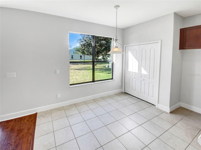 unfurnished dining area featuring light tile patterned floors