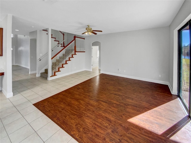 unfurnished living room featuring ceiling fan and light hardwood / wood-style floors