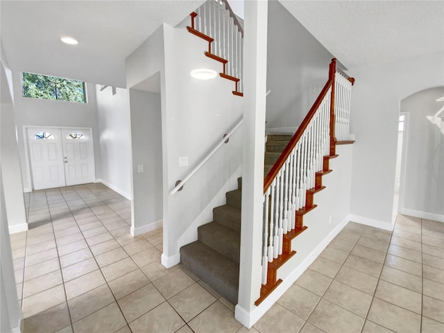 stairs with tile patterned floors