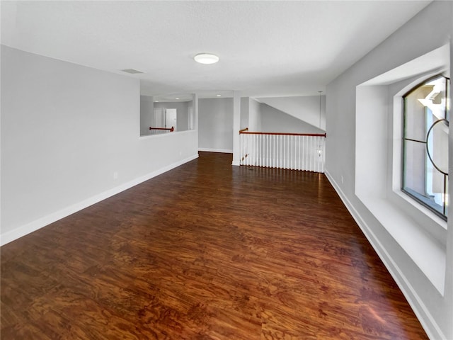 unfurnished room with dark hardwood / wood-style flooring