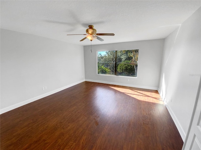 spare room featuring ceiling fan, dark hardwood / wood-style flooring, and a textured ceiling