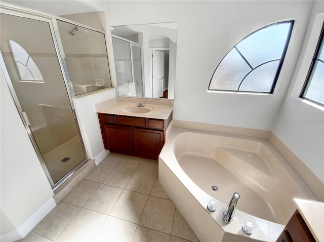 bathroom with tile patterned flooring, vanity, and shower with separate bathtub