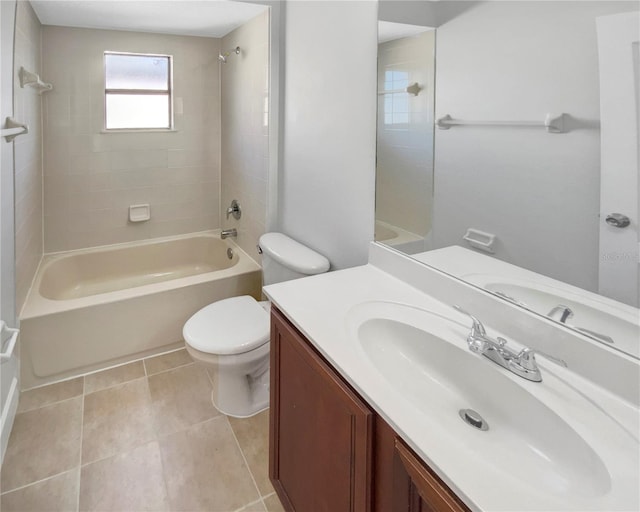 full bathroom featuring tile patterned flooring, vanity, toilet, and tiled shower / bath