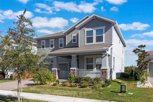 craftsman-style house with covered porch and a front yard