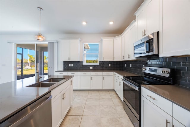 kitchen featuring plenty of natural light, sink, white cabinetry, and stainless steel appliances