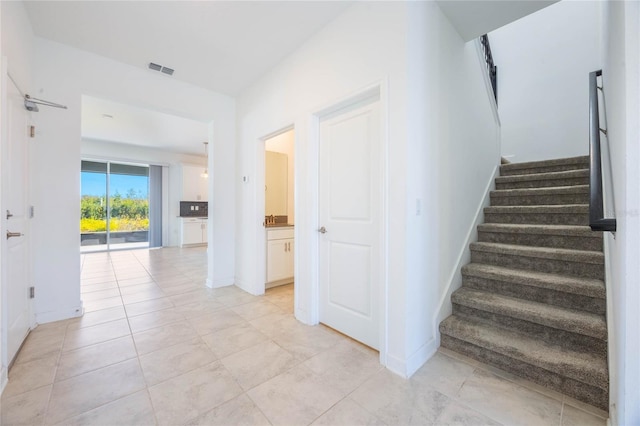 staircase with tile patterned floors