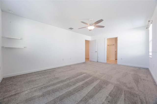 spare room featuring light colored carpet