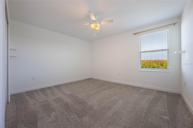 empty room with carpet flooring and ceiling fan