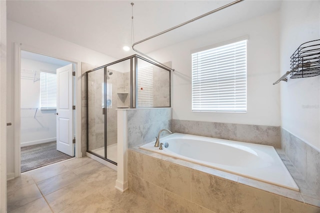 bathroom with tile patterned floors and independent shower and bath