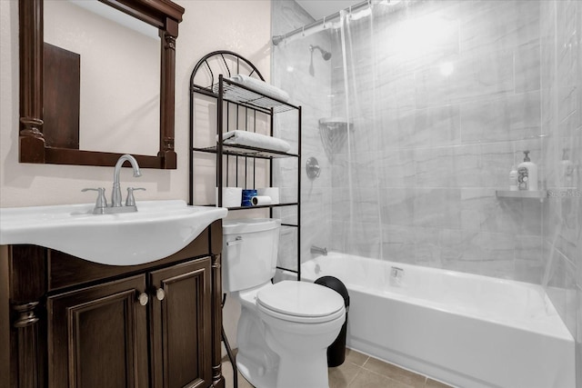 full bathroom featuring tile patterned floors, vanity, tiled shower / bath, and toilet