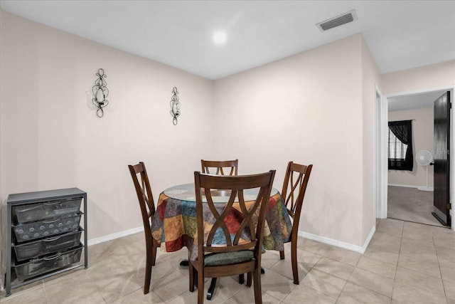 dining space featuring light tile patterned floors