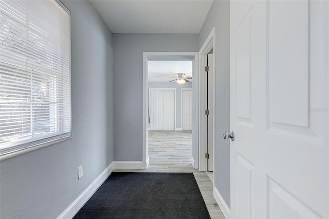 corridor with light wood-type flooring