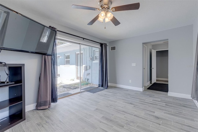 unfurnished room with ceiling fan and light hardwood / wood-style flooring