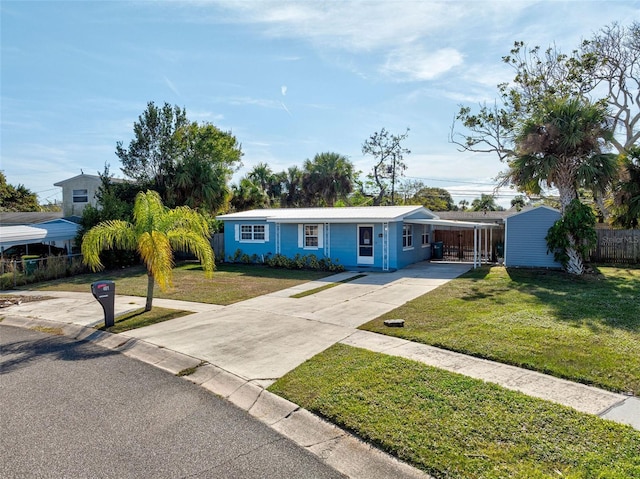 ranch-style house featuring a carport and a front yard