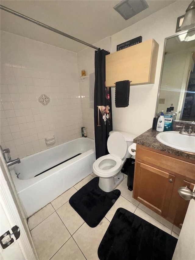 full bathroom with tile patterned flooring, shower / tub combo, vanity, and toilet