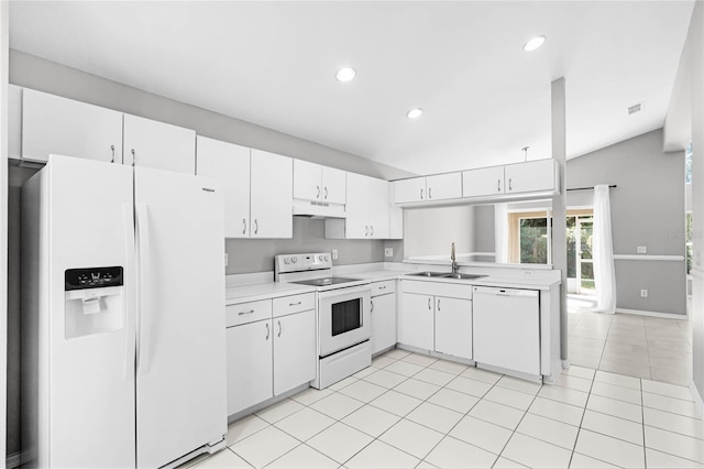 kitchen featuring sink, light tile patterned floors, vaulted ceiling, white appliances, and white cabinets