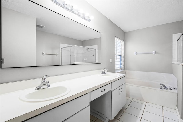 bathroom featuring tile patterned floors, plus walk in shower, vanity, and a textured ceiling