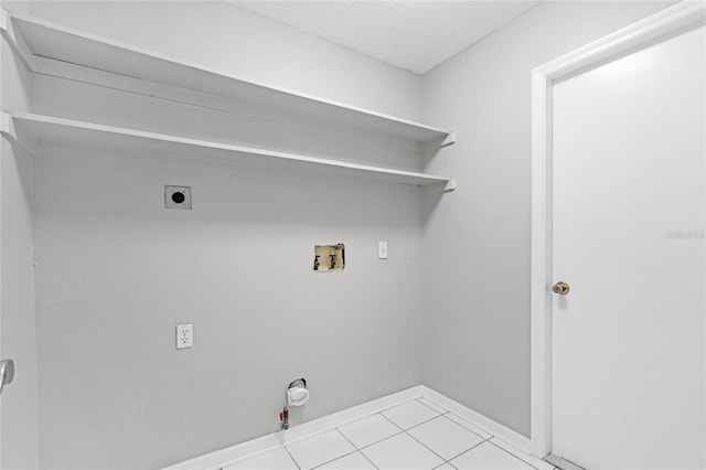 laundry area featuring hookup for a washing machine, hookup for a gas dryer, electric dryer hookup, and light tile patterned flooring