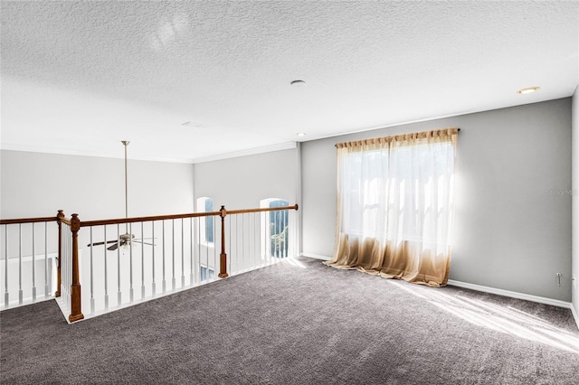 carpeted spare room with a textured ceiling