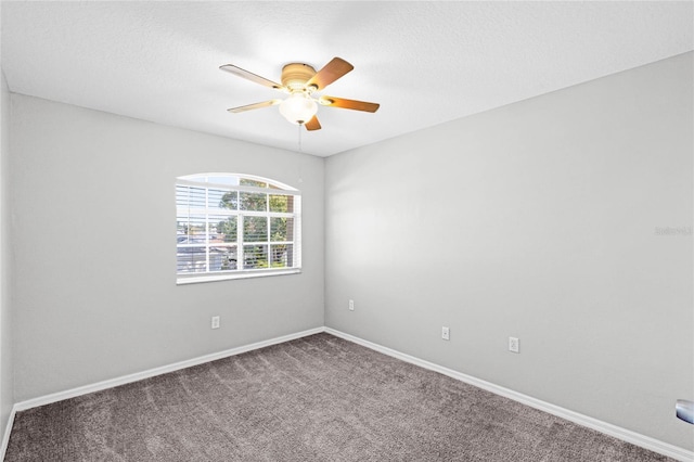 empty room with carpet flooring and ceiling fan