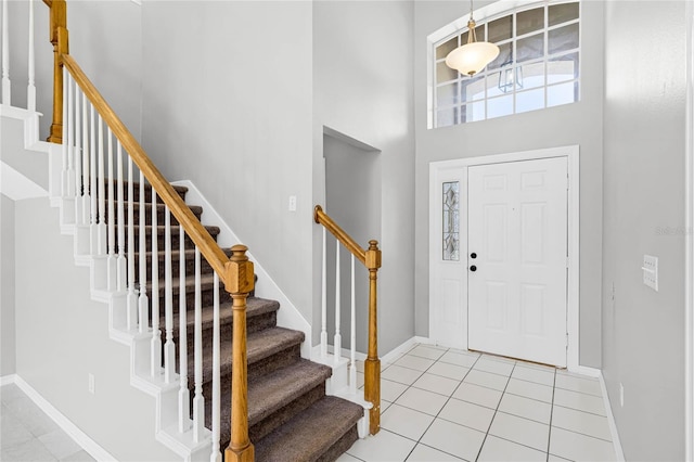 entrance foyer featuring a high ceiling and light tile patterned floors