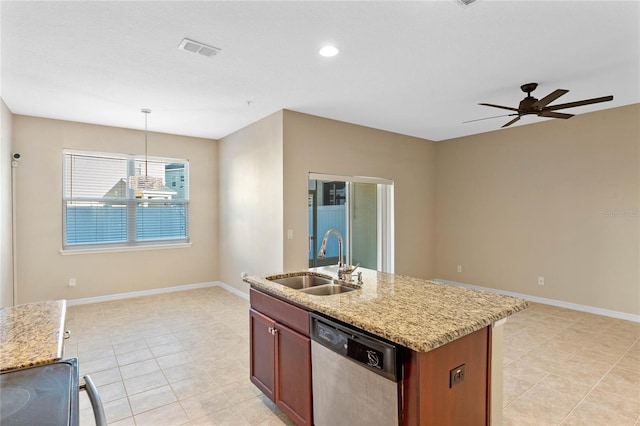 kitchen featuring ceiling fan, sink, hanging light fixtures, stainless steel dishwasher, and a center island with sink