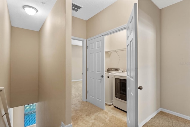 washroom featuring independent washer and dryer and light colored carpet