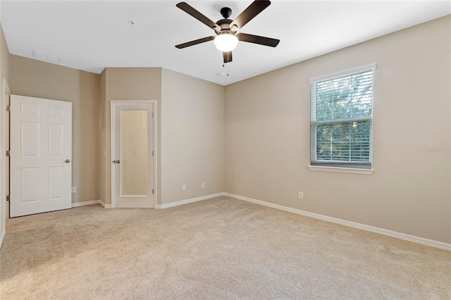 unfurnished room with ceiling fan and light colored carpet